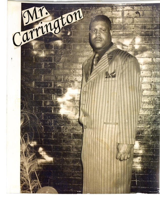 Gary Carrington poses in a pinstripe suit in front of a brick wall at Soakie's. There is text dubbing him "Mr. Carrington". 