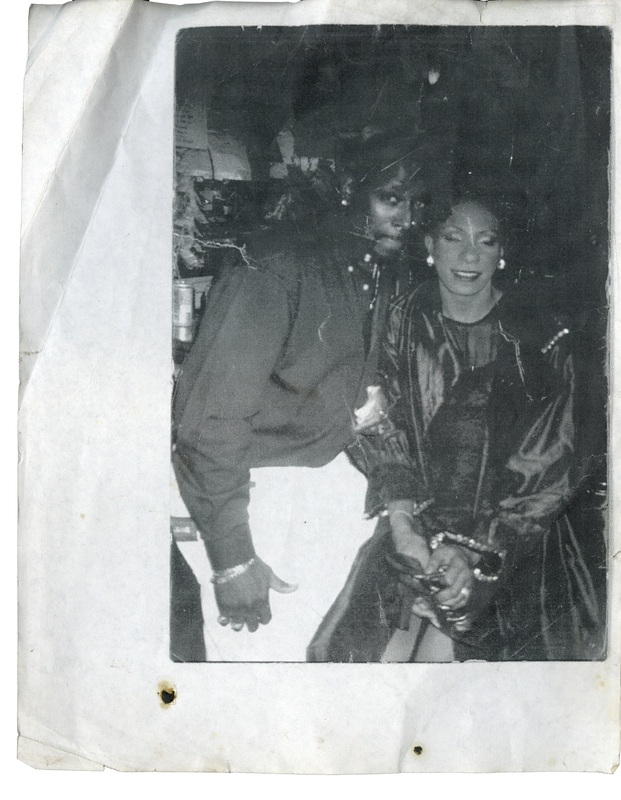 Two patrons pose at the bar in Soakie's----the photo is Black and white and printed on a piece of loose leaf, white paper.