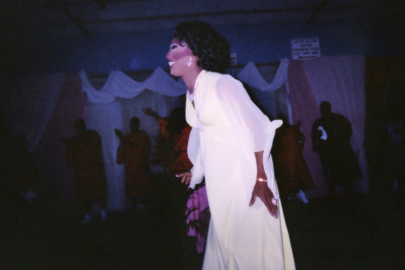 A feminine performer at Soakie's smiles to the audience